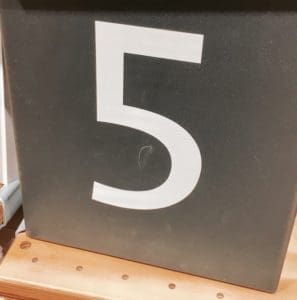 Number 5 on a shelf.